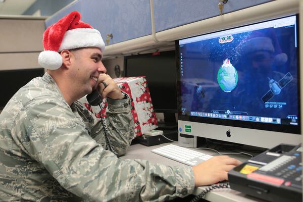 Maj. Jared Scott, makes sure NORAD's Santa tracker is working correctly at Tyndall Air Force Base on Friday, Dec. 23, 2016 in Panama City, Fla. (Heather Howard/News Herald via AP)