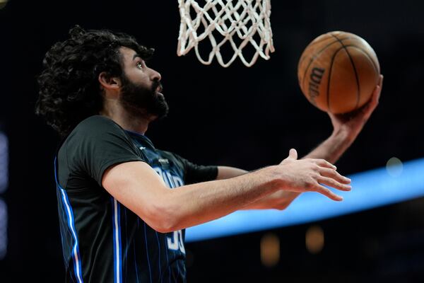 Orlando Magic center Goga Bitadze (35) shoots against the Atlanta Hawks during the first half of an NBA basketball game, Sunday, April 13, 2025, in Atlanta. (AP Photo/Mike Stewart)