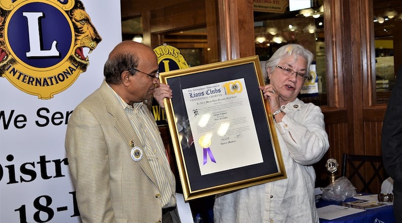The president of the Namaste Lions Club Chapter Ramesh Gude (left), receives the new club’s charter from Past International Director Kembra Smith. MARTY FARRELL FOR THE AJC
