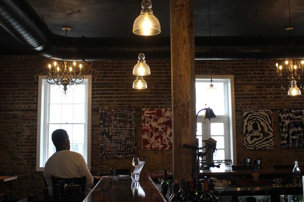 A single customer sits in 208 Wine Bar on East Bay Street. Hurricane Ian tracked further east, missing the Georgia coast and making landfall in South Carolina instead.