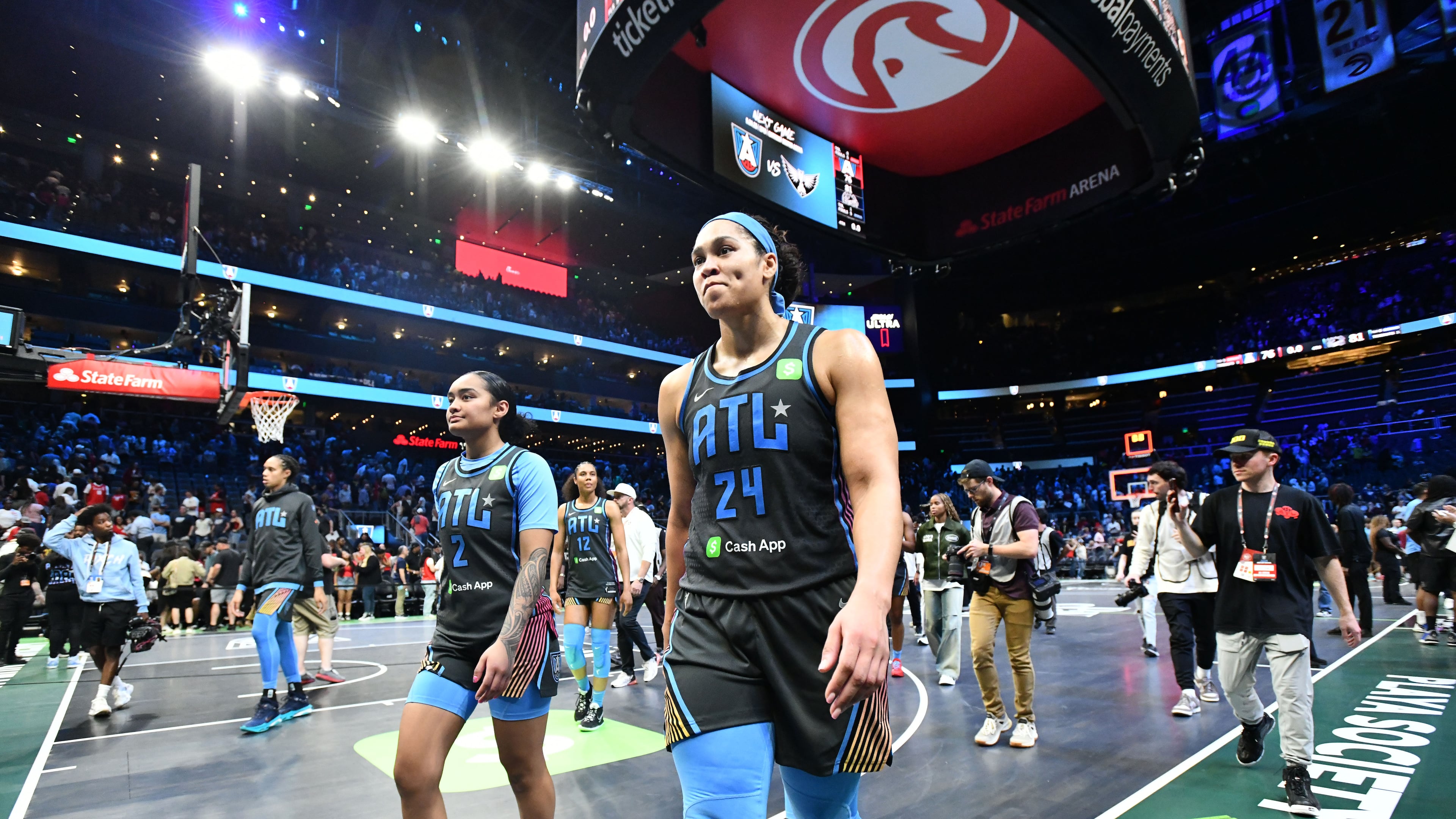 Atlanta Dream guard Te-Hina Paopao (left) and forward Brionna Jones leave the court after the Indiana Fever beat Atlanta 81-76 during the Dream’s home opener at State Farm Arena on Thursday. (Hyosub Shin/AJC)