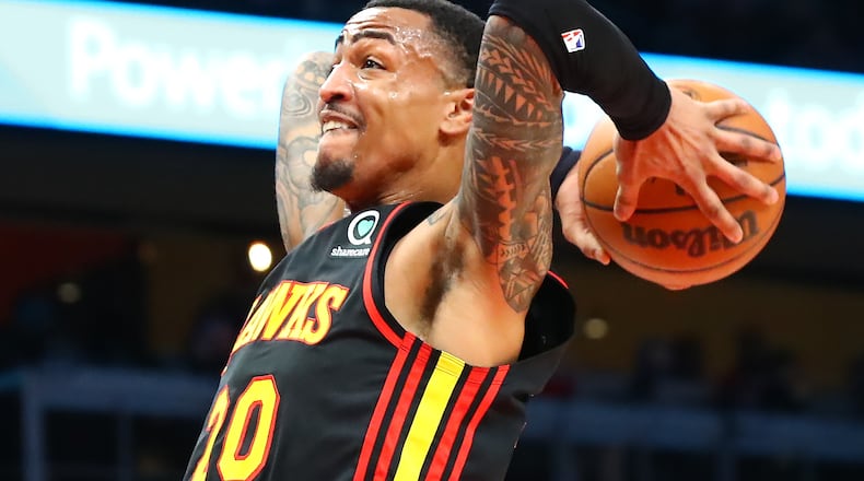 Hawks forward John Collins soars to the basket for a slam agains the Indiana Pacers during the first period in a NBA basketball game on Tuesday, Feb. 8, 2022, in Atlanta.  “Curtis Compton / Curtis.Compton@ajc.com”`