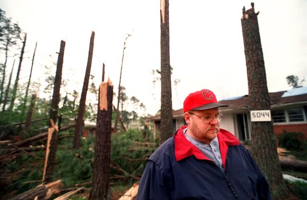 980410 - Marietta, Georgia - Gene Gaultney, who lives on Tilley Mill Rd., stands outside his house waiting for the insurance agent Friday, April 10, 1998. Gaultney said he had at least 40 pine trees in his front and back yards. He now has none. (AJC Staff Photo/Rich Addicks)