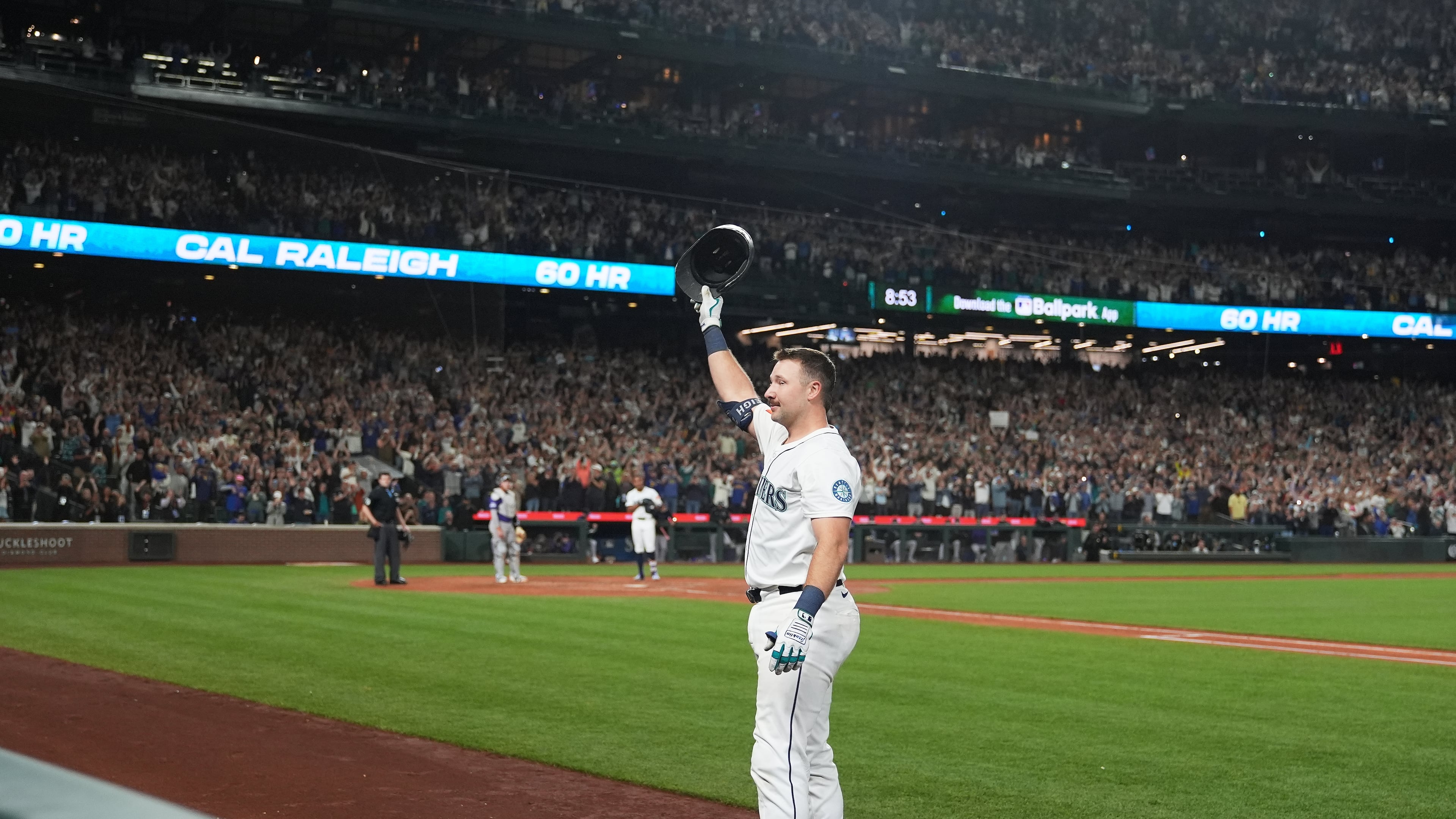 Seattle Mariners' Cal Raleigh waves to the crowd after hitting his 60th home run during the eighth inning of a baseball game against the Colorado Rockies, Wednesday, Sept. 24, 2025, in Seattle. (AP Photo/Ryan Sun)
