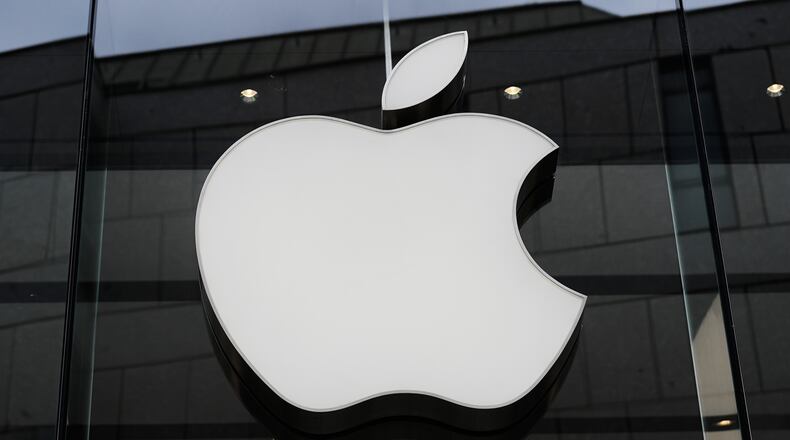 FILE - The Apple logo is illuminated at a store in Munich, Germany, April 2, 2026. (AP Photo/Matthias Schrader, File)