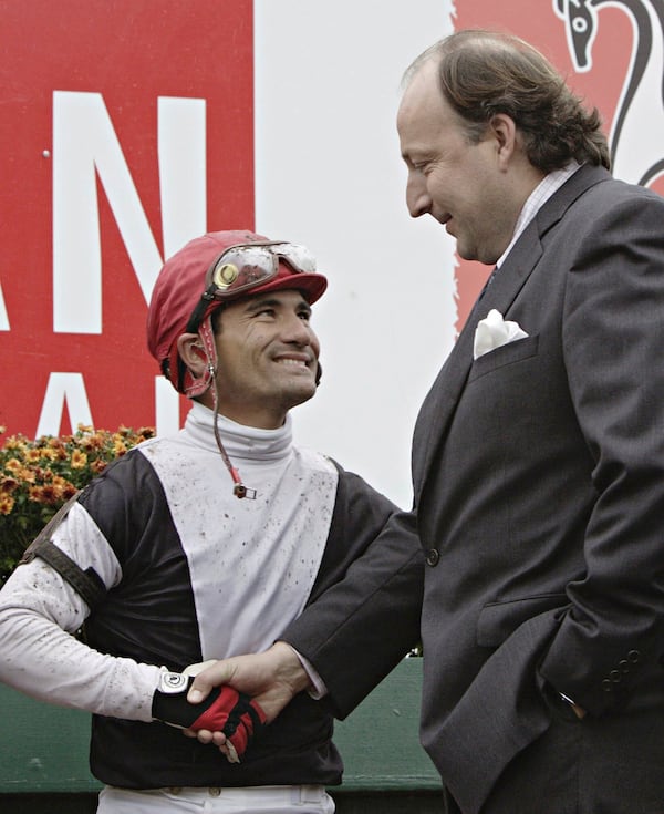 FILE - Jockey Corey Nakatani, left, shakes hands with trainer Christophe Clement after winning the Canadian International aboard Relaxed Gesture from Ireland at Woodbine Racetrack in Toronto, Sunday Oct. 23, 2005. (Frank Gunn/The Canadian Press via AP, File)