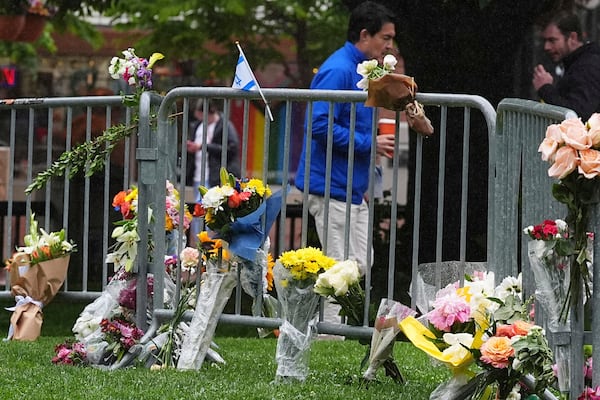 FILE - Bouquets of flowers stand along a makeshift memorial for victims of an attack outside of the Boulder County, Colo., courthouse on Tuesday, June 3, 2025, in Boulder, Colo. (AP Photo/David Zalubowski,File)
