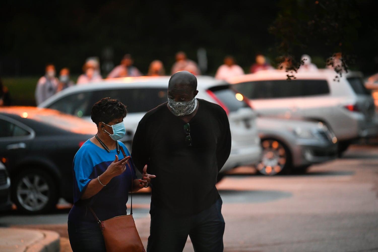 Gloria and Raymond Nolan talk while in line to vote as the first day of early voting gets underway on Monday, Oct. 12, 2020, at the Mountain Park Activity Building in Stone Mountain. The Nolan’s had been standing in the line which snaked through the parking lot for an hour arriving in the dark. JOHN AMIS FOR THE ATLANTA JOURNAL- CONSTITUTION