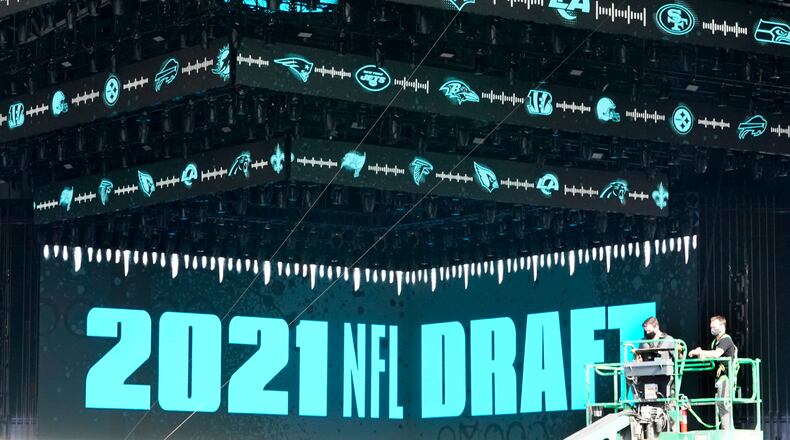 Workers continue preparing the NFL Draft Theatre for the 2021 NFL draft, Tuesday, April 27, 2021, in Cleveland. After going all virtual in 2020 due to the COVID-19 pandemic, the three-day draft, which has grown into one of America's biggest, non-game sporting events, returns with thousands of fans who will be separated by their loyalties, and whether they've been vaccinated. (AP Photo/Tony Dejak)