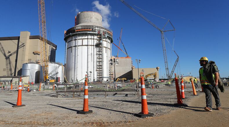 A construction worker walks by Plant Vogtle's Unit 4 on Tuesday, Dec 14, 2021, in Waynesboro, Georgia. “Curtis Compton / Curtis.Compton@ajc.com”`