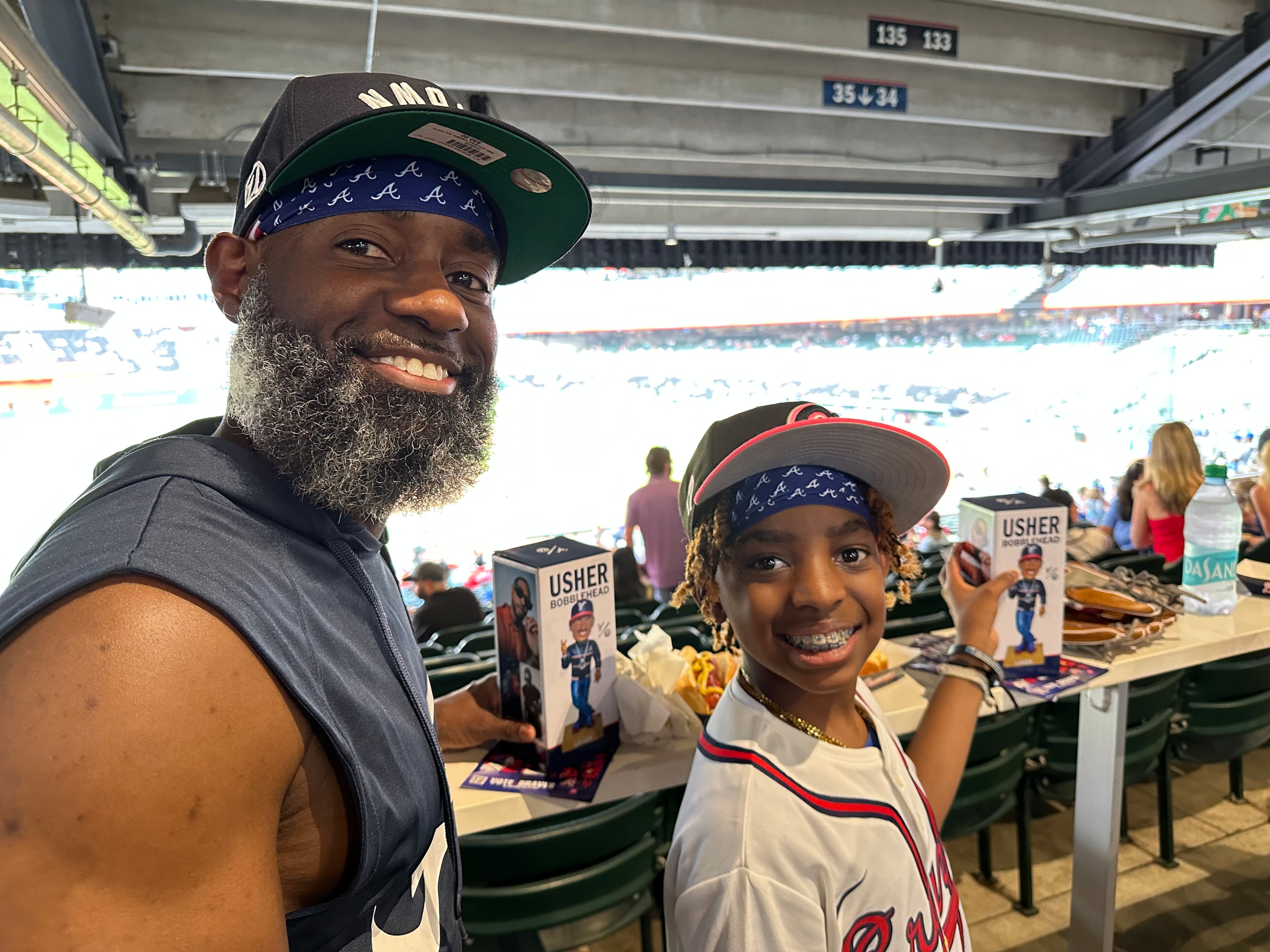 Richard James, an IT manager and Buckhead resident, brings his 12-year-old son Harper James to Braves games all the time and came early to ensure he got an Usher bobblehead. (Rodney Ho/AJC)