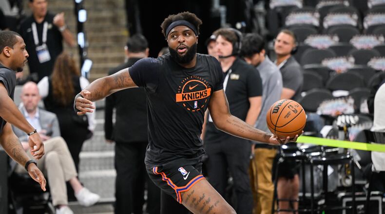 New York Knicks center Mitchell Robinson warms up prior to Game 5 of the NBA Finals basketball series against the San Antonio Spurs, Saturday, June 13, 2026, in San Antonio. (AP Photo/Darren Abate)