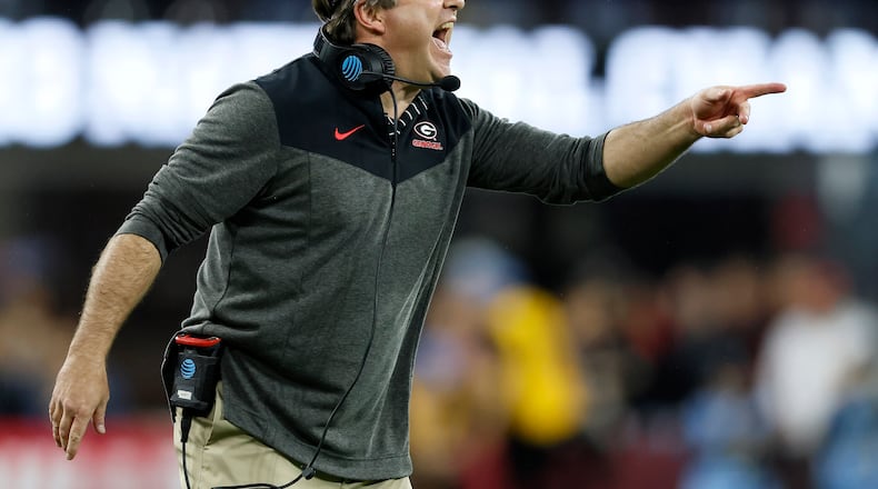 Georgia Bulldogs head coach Kirby Smart calls in a play against the TCU Horned Frogs during the second half of the College Football Playoff National Championship at SoFi Stadium in Los Angeles on Monday, January 9, 2023. Georgia won 65-7 and secured a back-to-back championship. (Jason Getz / Jason.Getz@ajc.com)