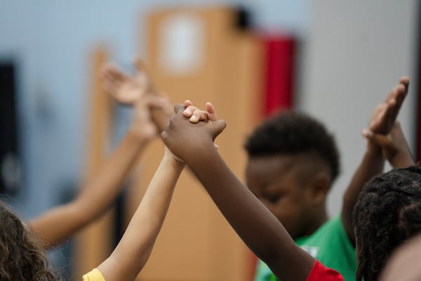 Children hold hands while participating in activities during the East Providence Boys and Girls Club Summer Camp at Emma G. Whiteknact Elementary School on Thursday, July 10, 2025, in Providence R.I. (AP Photo/Sophie Park)