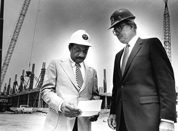 Herman Russell, left, the founder of H.J. Russell & Co., and Robert Holder of Holder Construction check the progress of the Delta Air Lines building near Virginia Avenue in College Park, July 18, 1983. (Lanna Swindler/AJC)