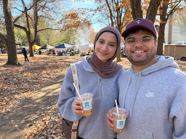 Newlyweds Layan Awad (left) and Othman Awad with coffee drinks from Bearly Awake Coffee on Sunday at the Atlanta Halal Fall Festival. (Ariel Hart/AJC)