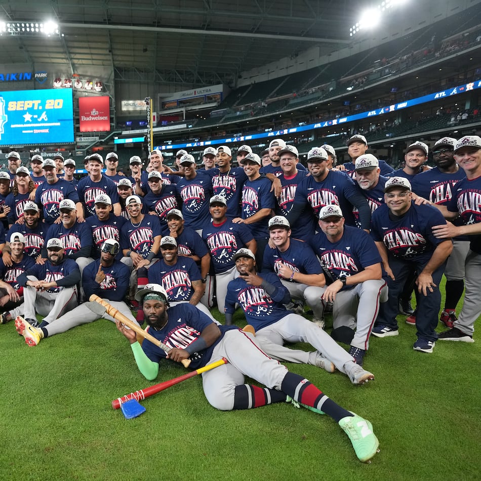 Atlanta Braves players and coaches take a group photo on the field after a baseball game against the Houston Astros as the Braves clinched the NL East title, Sunday, Sept. 20, 2026, in Houston. (Karen Warren/AP)