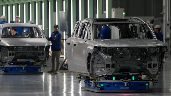 Employees work on the line during a media tour at the Hyundai Motor Group Metaplant America, Wednesday, March 26, 2025, in Ellabell, Ga. (AP Photo/Mike Stewart)