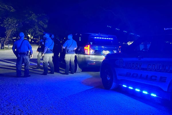 In this photo provided by the Horry County Police Department, police officers respond to the scene of a shooting on Sunday, May 25, 2025, in Little River, S.C. (Horry County Police Department via AP)