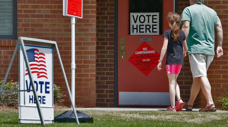 A steady flow of voters entered the polling place at Beautiful Savior Lutheran Church on Shallowford Rd. in Marietta. BOB ANDRES / BANDRES@AJC.COM