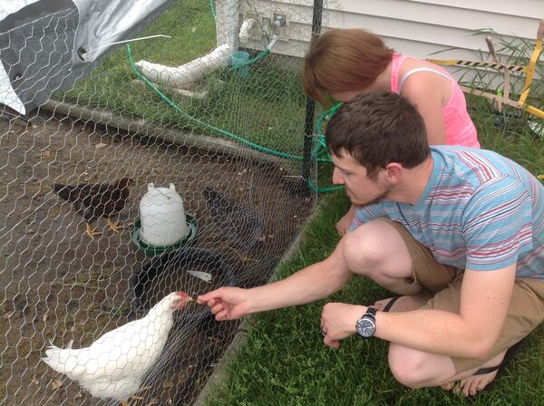 Brittany and husband Luke Villotti say the chickens they are keeping in their Montgomery subdivision backyard, are emotional support animals that have helped  Luke cope with the injuries he sustained while in the military.  "I take care of them and they take care of me," he says. (Denise Crosby/The Beacon-News/TNS)