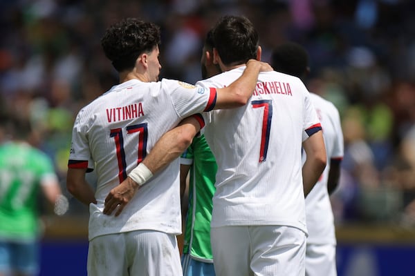 Paris Saint-Germain's Khvicha Kvaratskhelia, right, celebrates after scoring his side's first goal during the Club World Cup Group B soccer match between Seattle Sounders and PSG in Seattle, Monday, June 23, 2025. (AP Photo/Ryan Sun)