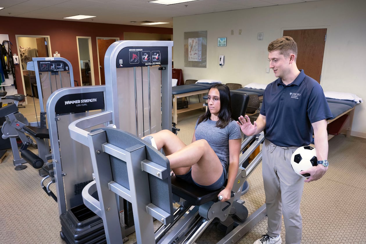Sports medicine physical therapist Carl Guidry (right) trains Katherine Kutscera at Emory Johns Creek Hospital. (Jack Kearse/Courtesy of Emory University)
