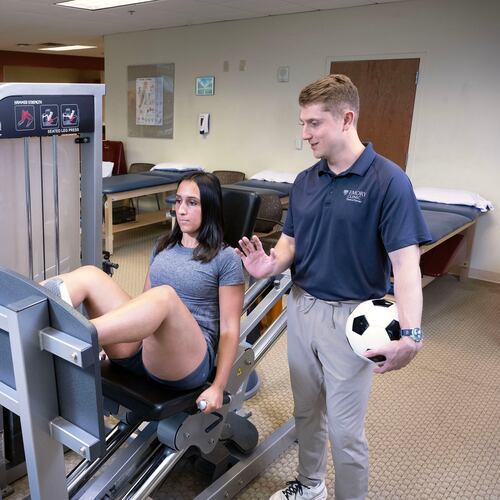 Sports medicine physical therapist Carl Guidry (right) trains Katherine Kutscera at Emory Johns Creek Hospital. (Jack Kearse/Courtesy of Emory University)