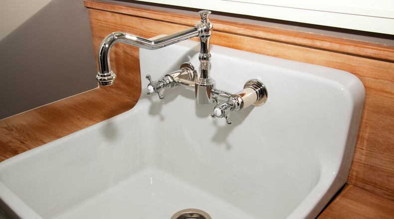 A utility sink is a deep single bowl sink designed to handle laundry and cleanup tasks. (Dreamstime)