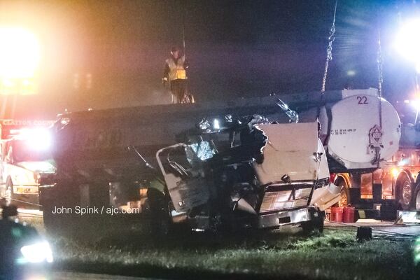 Several agencies responded to assist with cleanup efforts Tuesday morning after a tractor-trailer carrying gasoline overturned on I-675 in Clayton County, spilling fuel onto the interstate. JOHN SPINK / JSPINK@AJC.COM