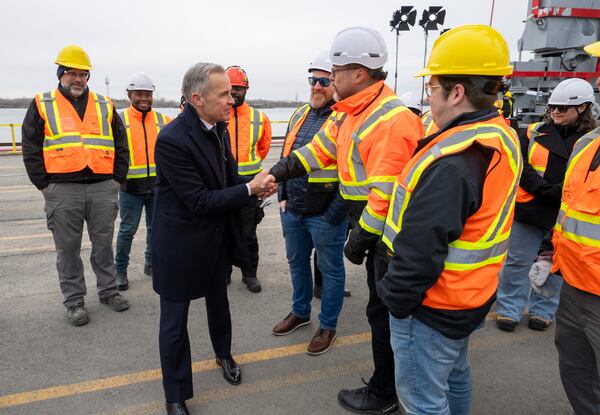 Liberal Leader Mark Carney greets workers following a campaign event at the Port of Montreal on Friday March 28, 2025. (Frank Gunn/The Canadian Press via AP)