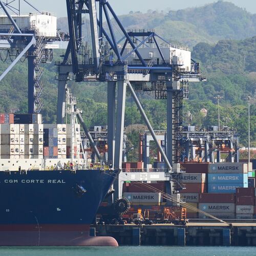 FILE - Cranes load a cargo ship at Panama Canal's Port of Balboa, managed by CK Hutchison Holdings, in Panama City, on Jan. 30, 2026. (AP Photo/Matias Delacroix, File)