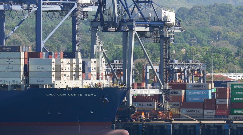 FILE - Cranes load a cargo ship at Panama Canal's Port of Balboa, managed by CK Hutchison Holdings, in Panama City, on Jan. 30, 2026. (AP Photo/Matias Delacroix, File)