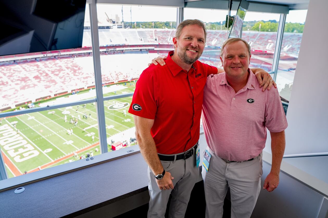New Georgia Bulldogs radio play-by-play voice Jeff Dantzler (right) poses with Bulldogs football great and radio analyst Jon Stinchcomb before the season opener against Tennessee State at Sanford Stadium Sept. 5, 2026. (Tony Walsh/UGAAA)
