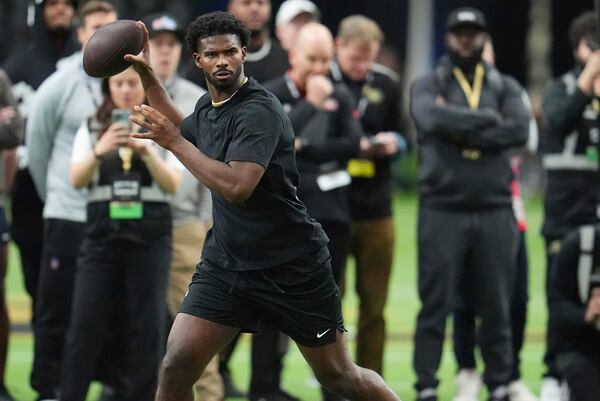 As scouts look on, Colorado quarterback Shedeur Sanders takes part in passing drills during the team's NFL football pro day Friday, April 4, 2025, in Boulder, Colo. (AP Photo/David Zalubowski)