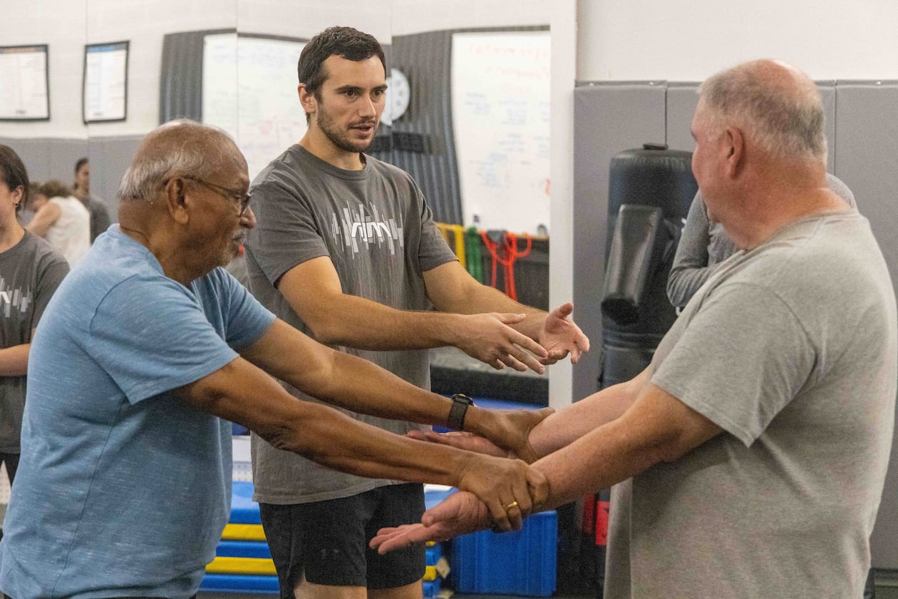 Atlanta Judo Midtown's Jacob Becerra (center) gives Shankaran Mahadevan (left) and Jim Tebbel instruction during the new 6-week Strong and Stable, Safe-Falling Program for Seniors.(Phil Skinner for the AJC)