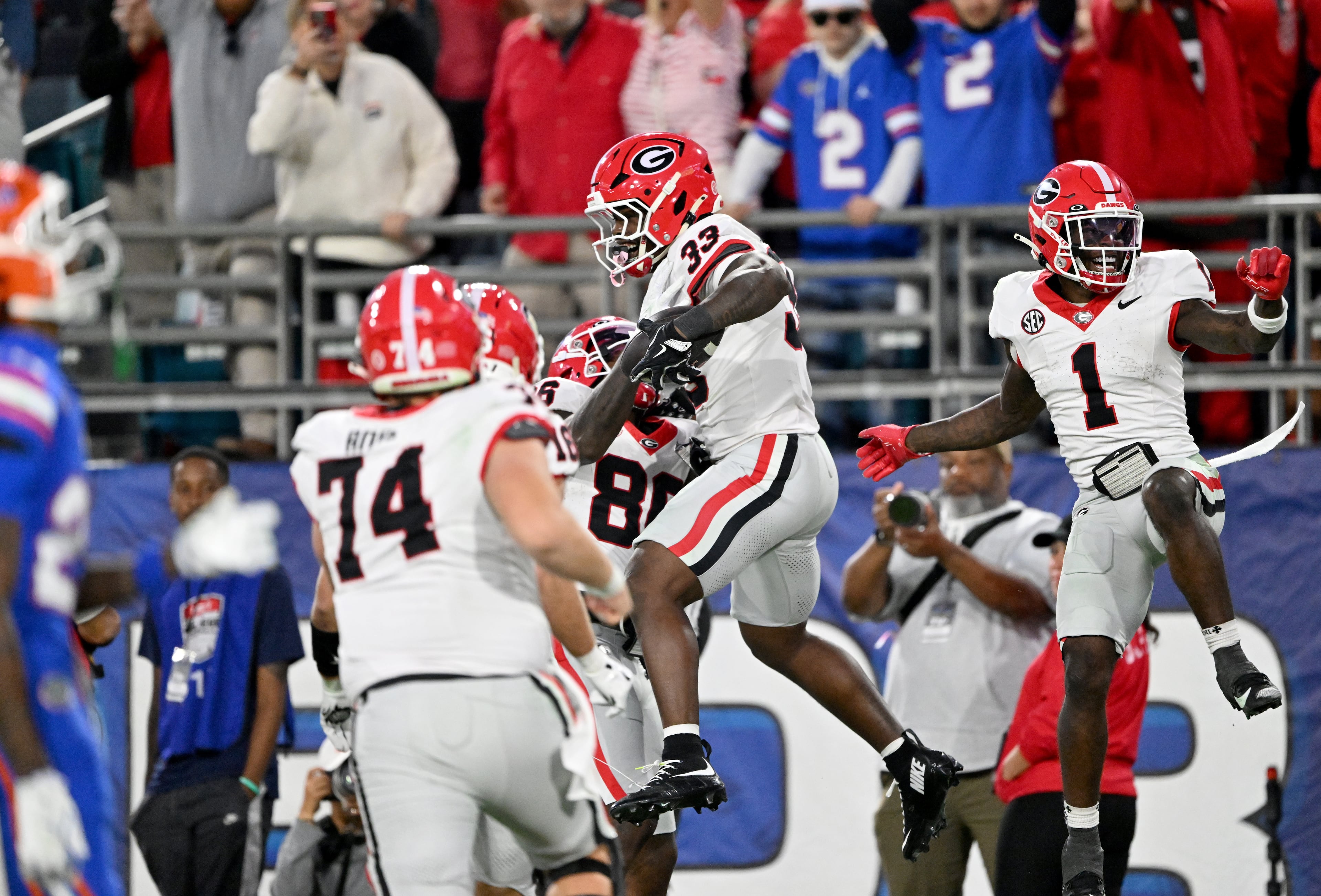 Georgia running back Chauncey Bowens (33) celebrates with teammates after scoring a touchdown during the second half in an NCAA football game, Saturday, November 1, 2025, Jacksonville, Fla. Georgia won 24-20 over Florida. (Hyosub Shin / AJC)