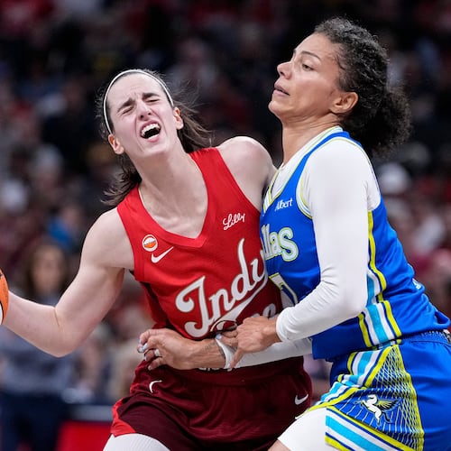 Indiana Fever guard Caitlin Clark, left, is fouled by Dallas Wings forward Alysha Clark, right, in the first half of a WNBA basketball game in Indianapolis, Friday, Aug. 14, 2026. (AP Photo/Michael Conroy)