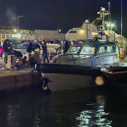 Greek coast guard officers carry out rescue operations at a port on the eastern Aegean island of Chios, Greece, late Tuesday, Feb. 3, 2026, after a collision between a migrant speedboat and a coast guard patrol vessel killed multiple people, authorities said. (Pantelis Fykaris/Politischios.gr via AP)