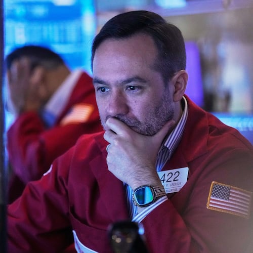 Trader Robert Greason works on the floor of the New York Stock Exchange, Friday, Nov. 14, 2025. (AP Photo/Richard Drew)