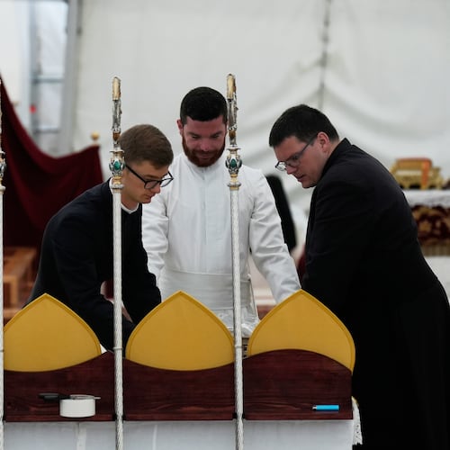 Priests prepare miters and pastoral staffs before the start of a consecration ceremony for four new bishops, in a tent set up outside the Society of St. Pius X seminary, in Econe, Switzerland, Wednesday, July 1, 2026. (AP Photo/Baz Ratner)