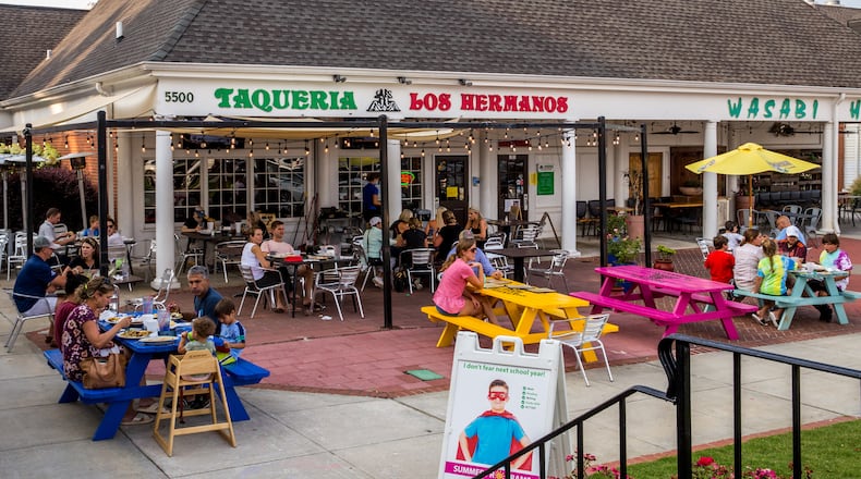 Dunwoody Village businesses, including Taqueria Los Hermonos in The Shops of Dunwoody strip mall, may soon have a new city center, in the mean time the locals enjoy whatever green space and outdoor patios they can find in the multiple shopping complexes, patched together in the area on Thursday, July 22, 2021. (Jenni Girtman for The Atlanta Journal-Constitution)