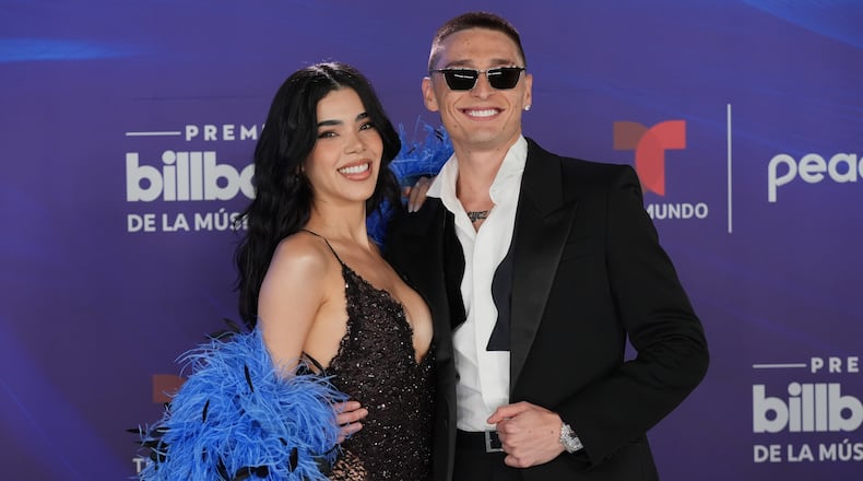 Kenia Os and Peso Luma arrive at the Latin Billboard Awards Thursday, Oct. 23, 2025, in Miami. (AP Photo/Marta Lavandier)