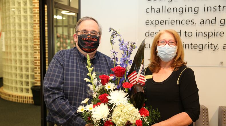 Johnny Griffin receives patriotic flowers from Philadelphia Winn’s Historian Kathy Lobe after being selected as the DAR Chapter’s 2021 nominee for Outstanding Teacher of American History. It was recently announced that Griffin has also
been selected by the Georgia State Society DAR as Outstanding Teacher of American History and will be honored during the GSSDAR Annual Conference at Evergreen Conference Center in March.
