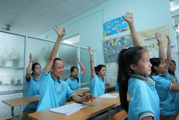 Nguyen Thanh Hai, 34, centre, raises his hand to answer question during class at a school for victims of Agent Orange in Da Nang, Vietnam, March 7, 2025. (AP Photo/Hau Dinh)