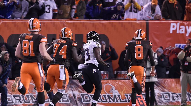 CLEVELAND, OH - NOVEMBER 30: Will Hill #33 of the Baltimore Ravens returns a blocked field goal for a touchdown in front of Jim Dray #81, Cameron Erving #74 and Andy Lee #8 of the Cleveland Browns during the fourth quarter at FirstEnergy Stadium on November 30, 2015 in Cleveland, Ohio. Baltimore won the game 33-27. (Photo by Jason Miller/Getty Images)