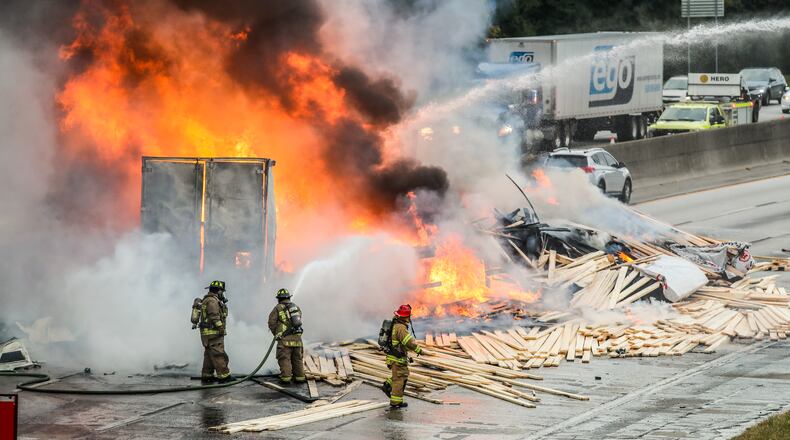 October 21, 2021 Fulton County: In the kind of calamity only possible in metro Atlanta traffic, two trucks carrying loads of lumber and candles collided on I-285 and burst into flames Thursday, Oct. 21, 2021. (John Spink / John.Spink@ajc.com)