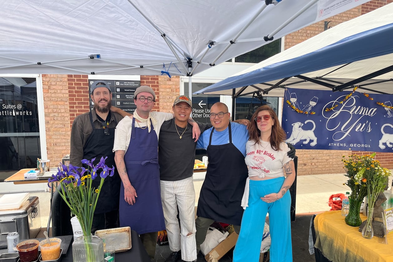5 people are posed and smiling in front of Puma Yu's restaurant. Two of them are chefs from Talat Market (Rod Lassiter and Parnass Savang) and three are from Puma Yu's (Sam Gibbon, Pete Amadhanirundr and Ally Smith)
