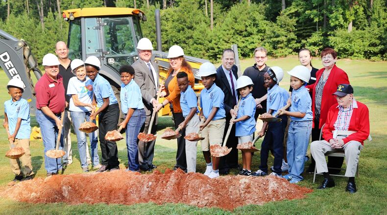 Students from Graves Elementary School, Gwinnett County commissioners and members of the Graves Family break ground on the Graves Park Phase II expansion. Courtesy Gwinnett County
