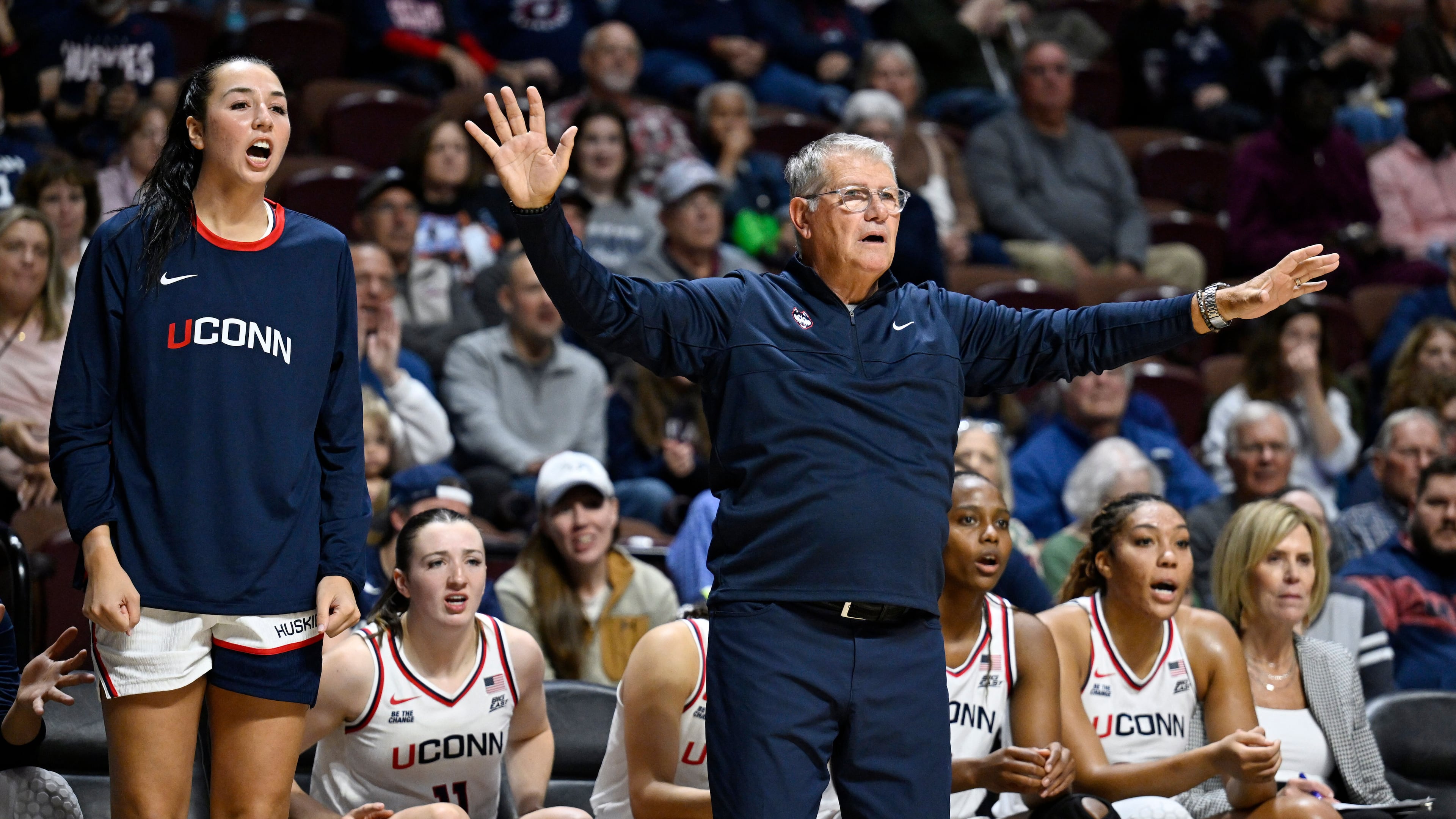 UConn head coach Geno Auriemma gestures as player Caroline Ducharme, left, calls out to their team in the first half of an exhibition NCAA college basketball game against Boston College, Monday, Oct. 13, 2025, in Uncasville, Conn. (AP Photo/Jessica Hill)